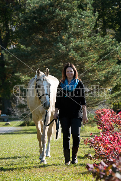 Woman with a palomino horse