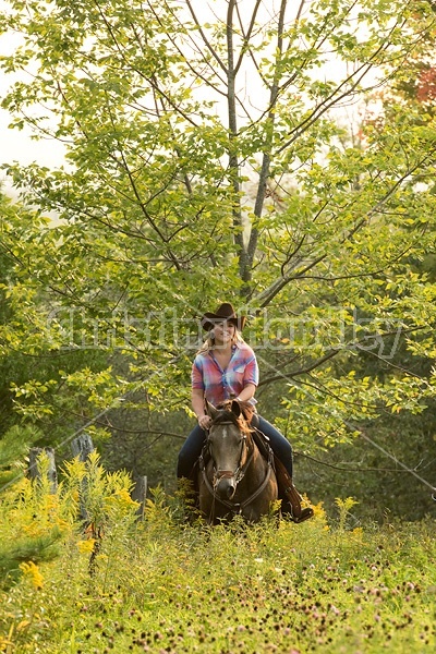 Young woman horseback riding western 