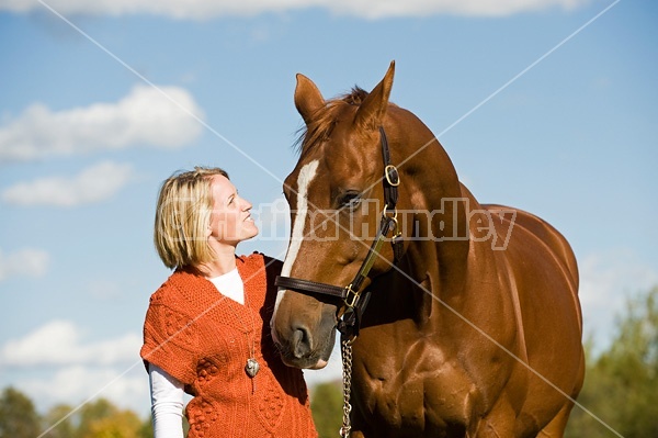 Young woman with her horse