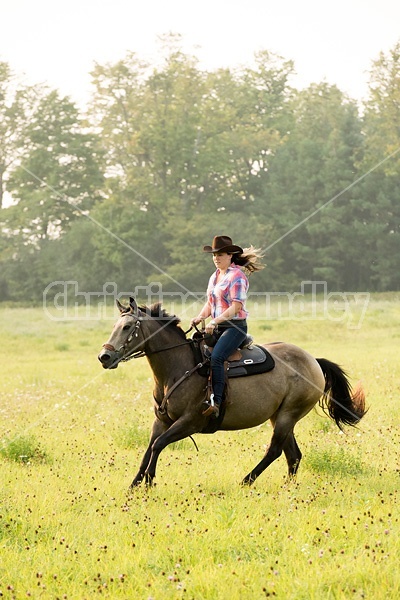 Young woman horseback riding western 