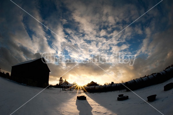 Winter barnyard in the evening setting sun