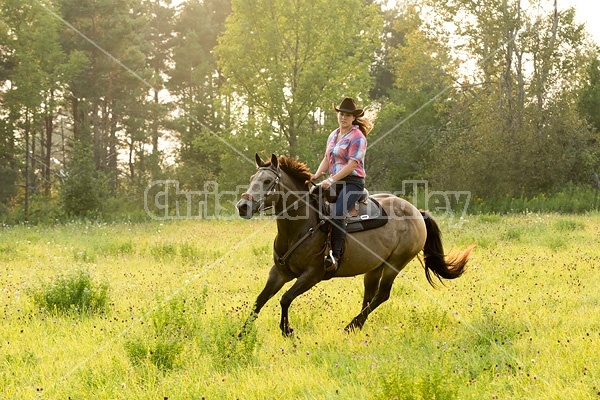 Young woman horseback riding western 