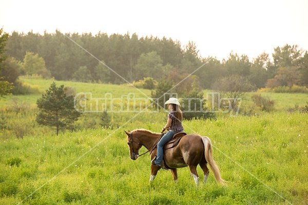 Young woman horseback riding western 