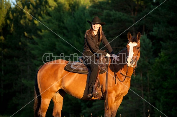 Young woman riding her American Paint horse mare