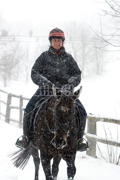 Woman horseback riding in the winter