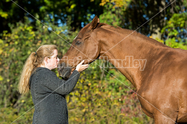 Woman with her Thoroughbred horse