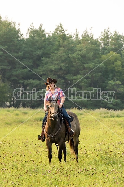 Young woman horseback riding western 