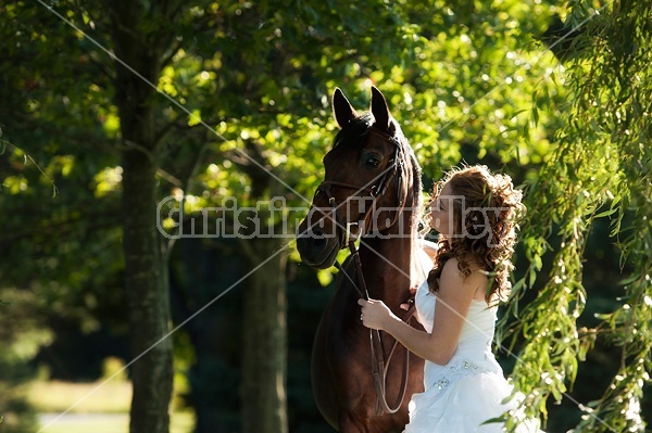 Woman in wedding dress with horse.