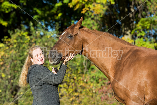 Woman with her Thoroughbred horse