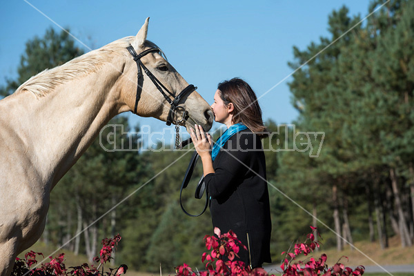 Woman with a palomino horse