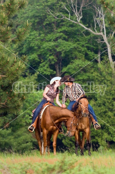 Young couple horseback riding