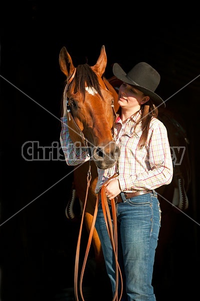 Portrait of a young woman and her American Quarter Horse gelding