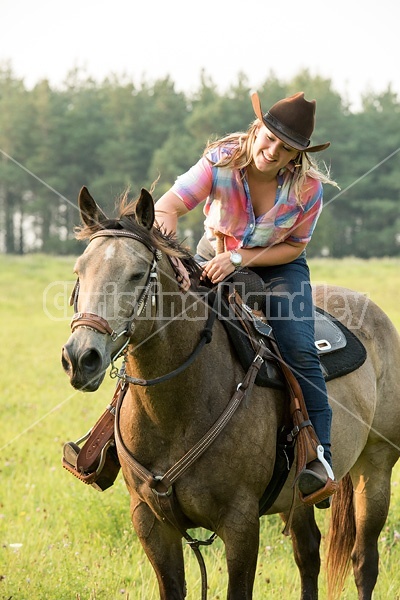 Young woman horseback riding western 