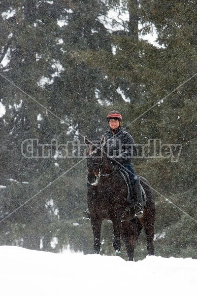 Woman horseback riding in the winter