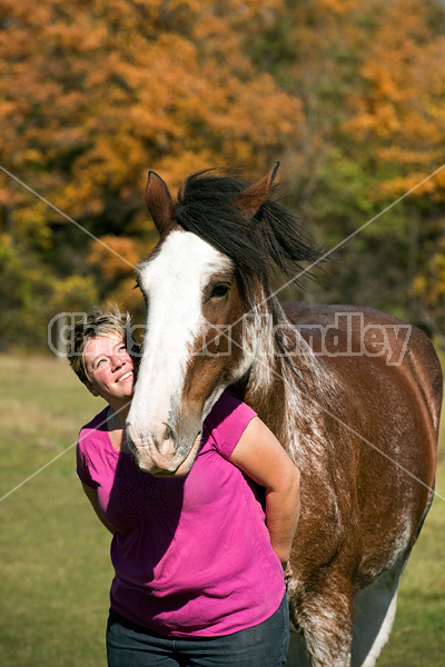 Portrait of a woman with her Clydesdale draft horse