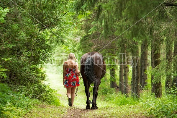 Young woman with her dark bay horse