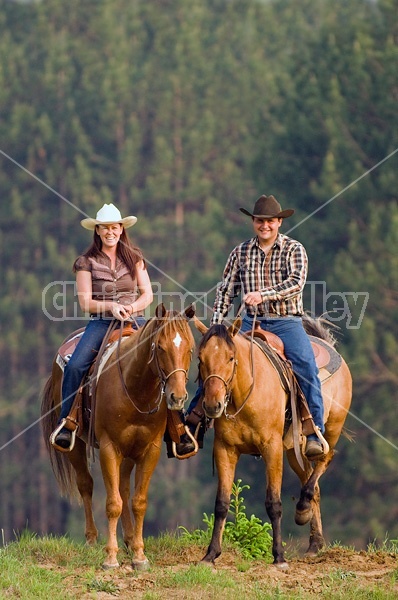 Young couple horseback riding