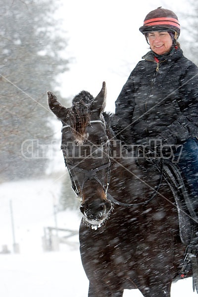 Woman horseback riding in the winter