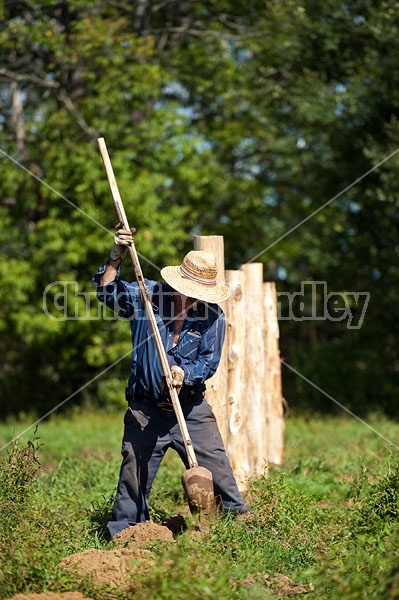 Farmer building new fence